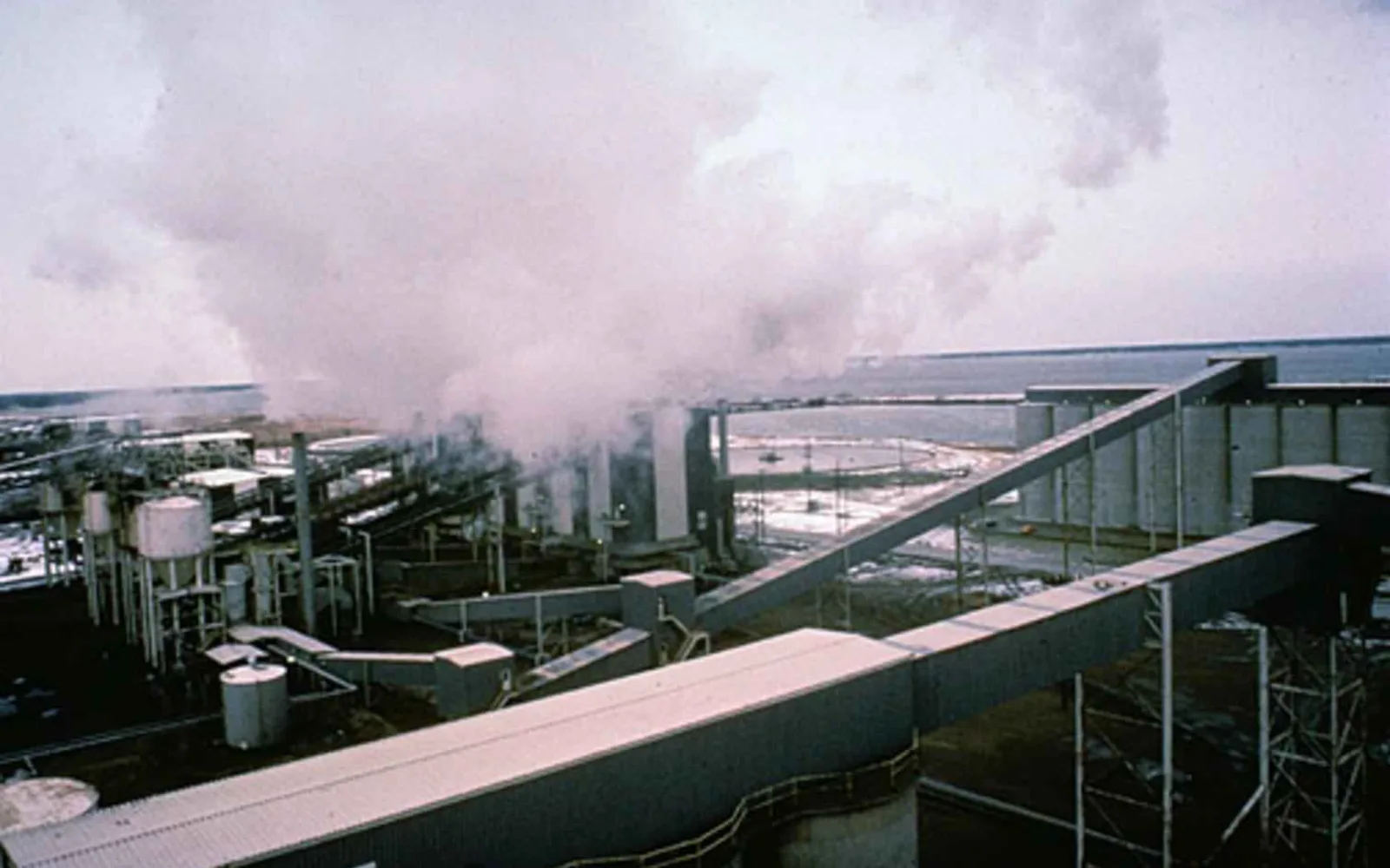 Industrial plant facility with metal structures, towers, and processing equipment